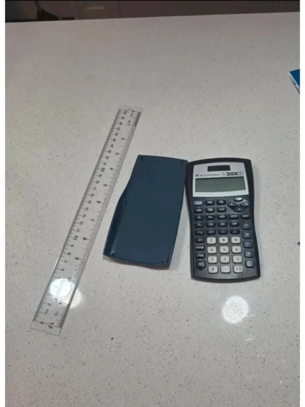 Office supplies and ruler and calculator on next photo